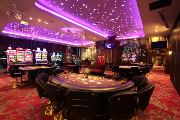 A man focused on his laptop with live stats in the background, highlighting the dedicated sports and gaming features of the ALWAFA mobile app.