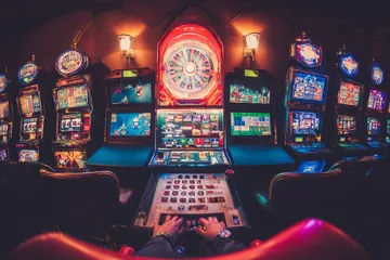 A close-up shot of golden coins falling around a spinning roulette wheel, representing immersive casino action at ALWAFA.