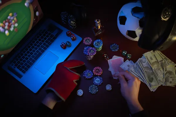 A glowing roulette wheel with cascading chips, symbolizing the engaging live and instant-win games available on ALWAFA.