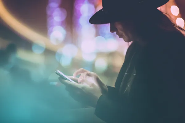 A woman in a luxurious green gown next to an ornate roulette wheel, capturing the upscale casino mood of ALWAFA.