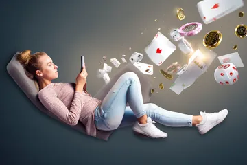 A player using their smartphone during a festive local event, representing ALWAFA’s fully mobile-friendly casino.